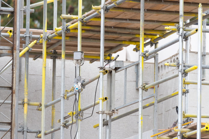 Tube and clamp scaffolding is being used at the construction site.